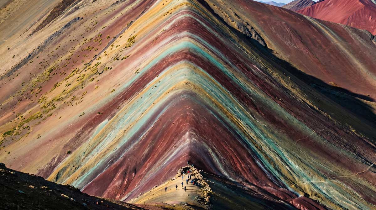Striped red, turquoise and gold mineral bands of Rainbow Mountain (Vinicunca) in Peru