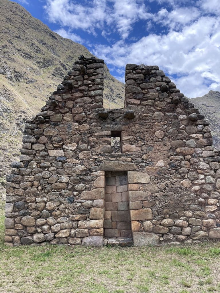 A tall Inca gable wall with a trapezoidal doorway at a site beside the trail on Day 1