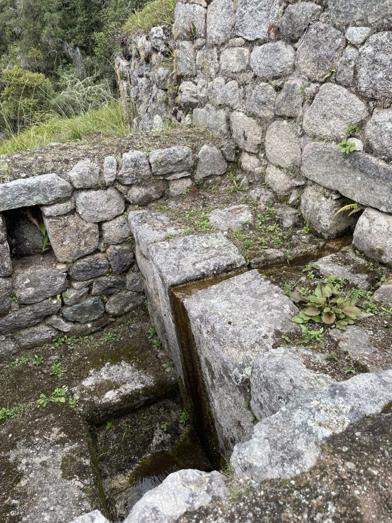 A carved stone water channel of the Inca fountains at Wiñay Wayna