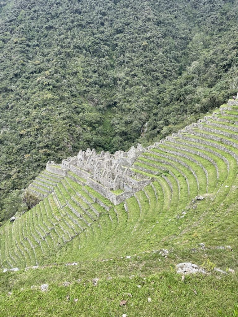 The curved agricultural terraces and stone buildings of Wiñay Wayna